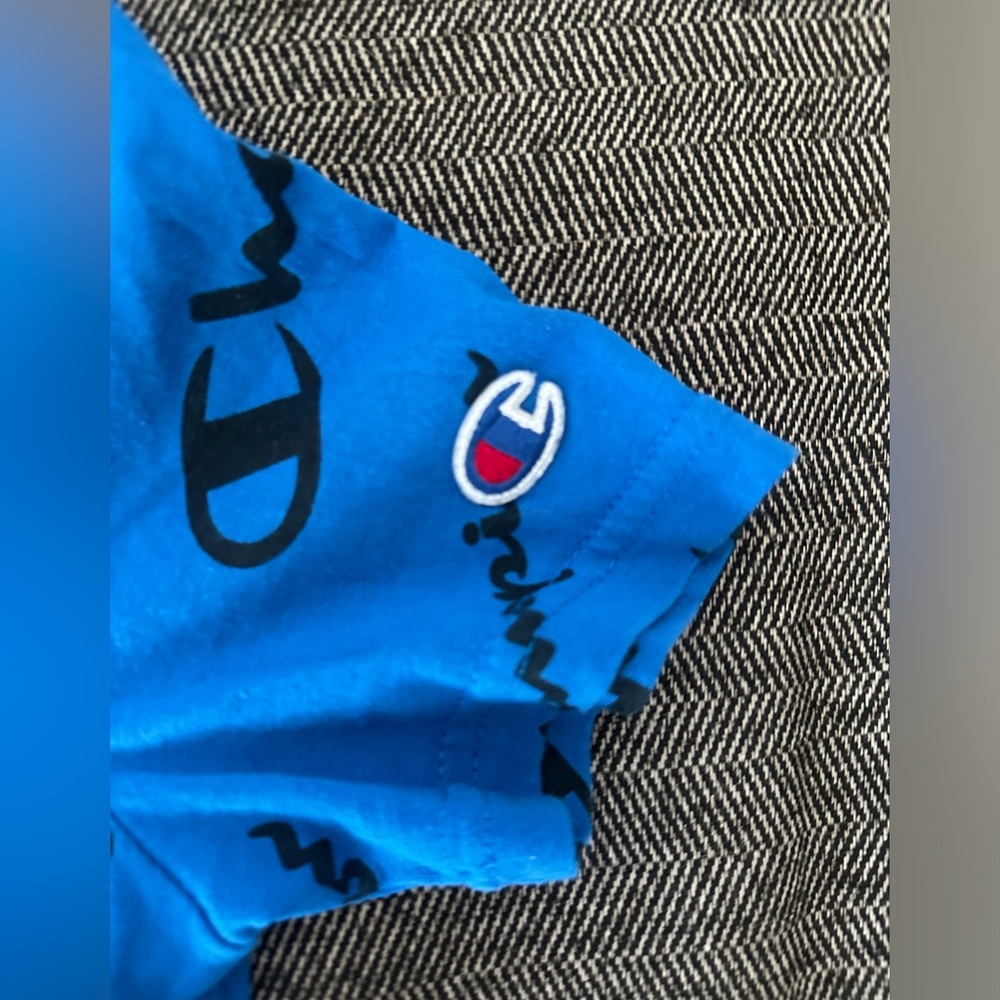 Blue Champion shirt with wording covering front and back of the shirt - Picture 3 of 3